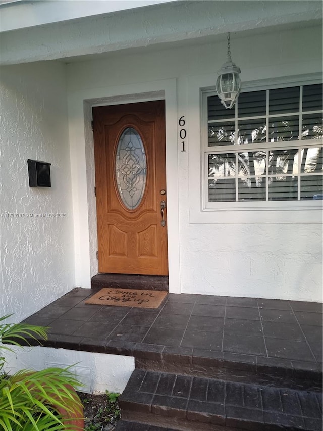 view of exterior entry with a porch