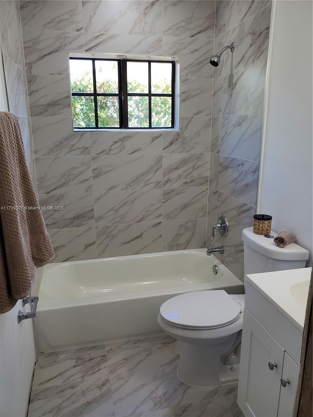 full bathroom featuring tiled shower / bath, vanity, and toilet