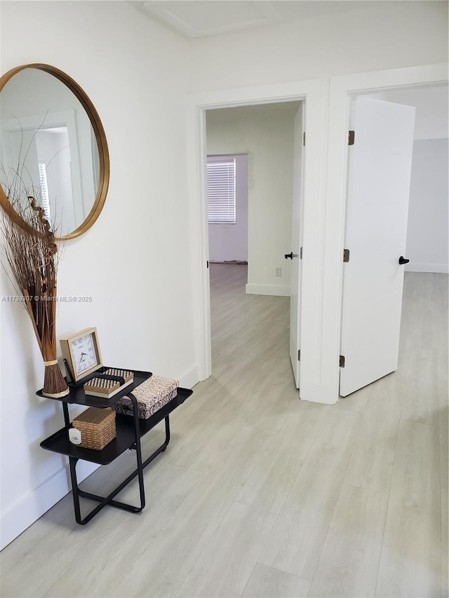 hallway with light hardwood / wood-style flooring