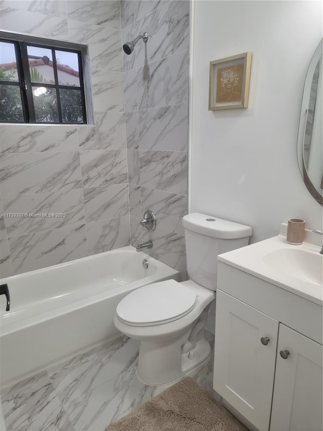 full bathroom with vanity, toilet, and tiled shower / bath