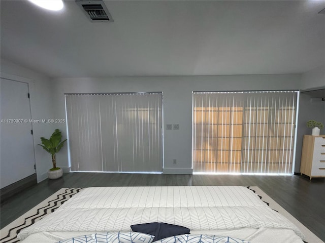 bedroom with dark hardwood / wood-style flooring