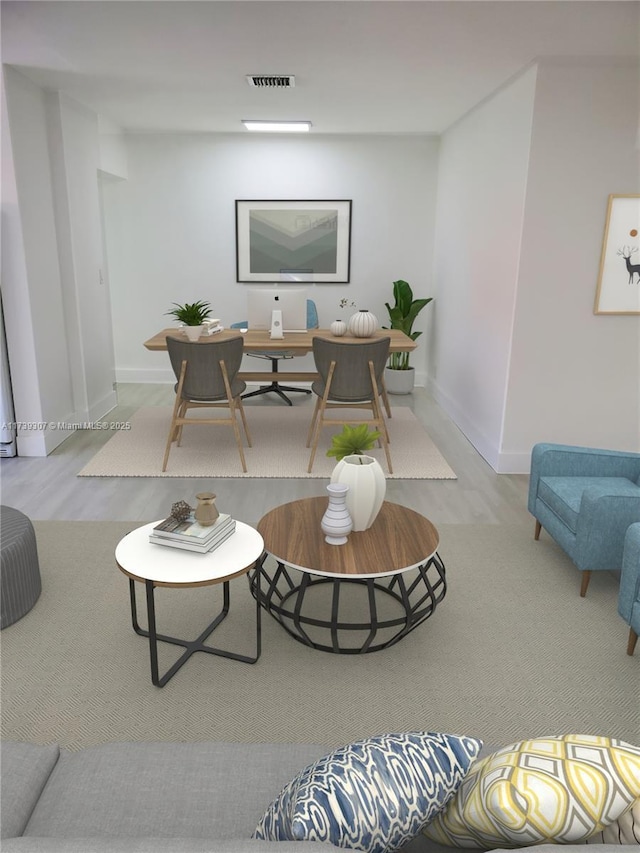 interior space featuring baseboards, wood finished floors, and visible vents