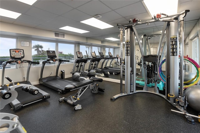 workout area with a paneled ceiling