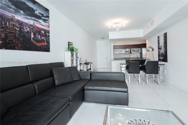 tiled living room featuring sink