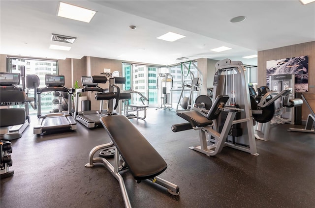 workout area with expansive windows and wooden walls