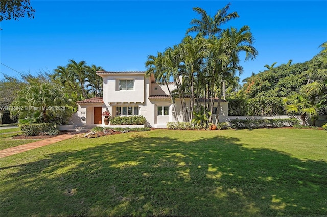 mediterranean / spanish home with a front yard