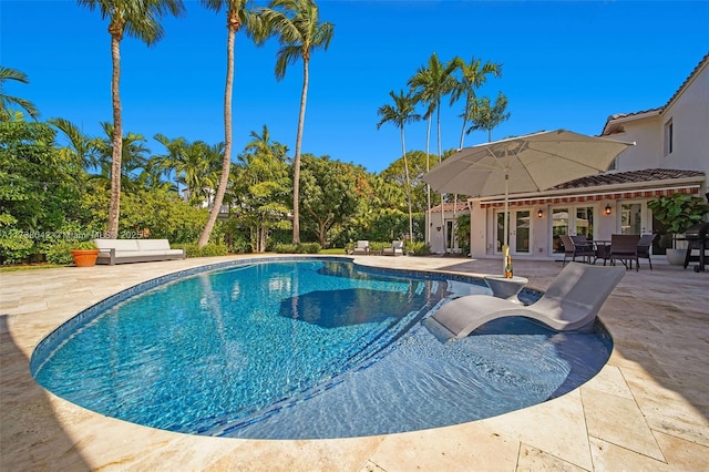 pool featuring a patio and french doors