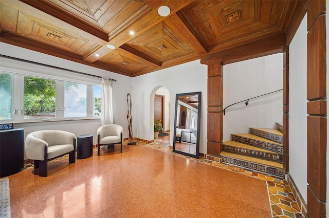 sitting room featuring wood ceiling, baseboards, coffered ceiling, and crown molding