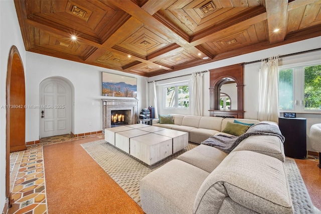 living room featuring arched walkways, a lit fireplace, wooden ceiling, and baseboards