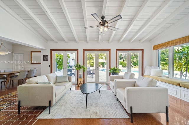 living area featuring lofted ceiling with beams and french doors