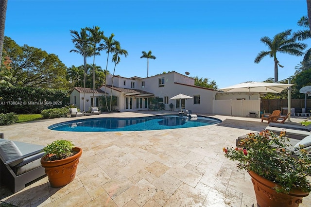 view of swimming pool featuring fence, a fenced in pool, and a patio