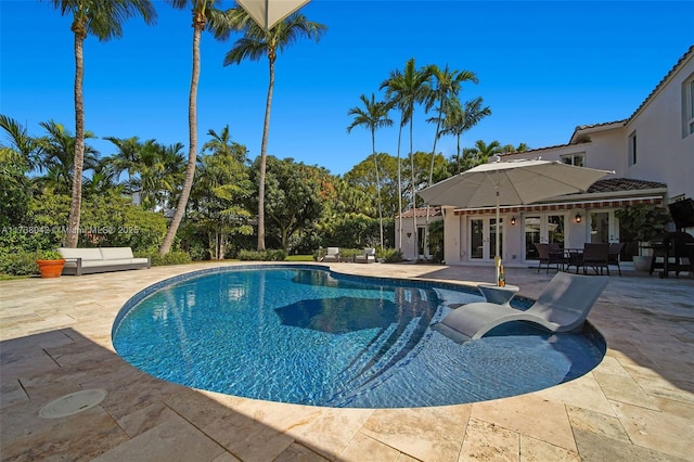 pool with a patio area and french doors