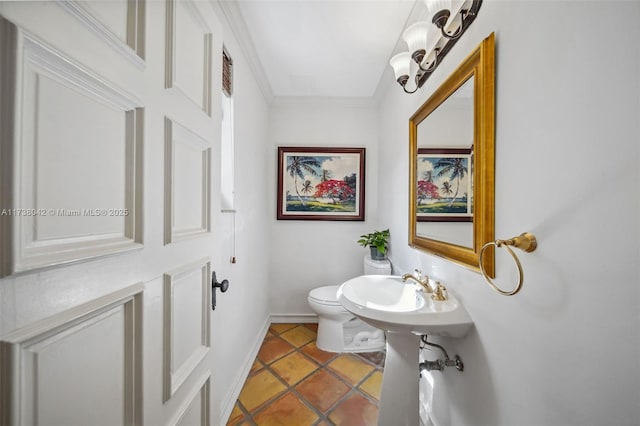 half bath with ornamental molding, tile patterned flooring, toilet, and baseboards