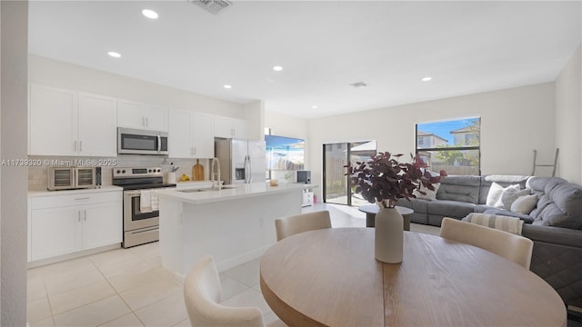 tiled dining space featuring sink