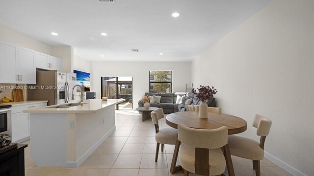 dining room with sink and light tile patterned floors