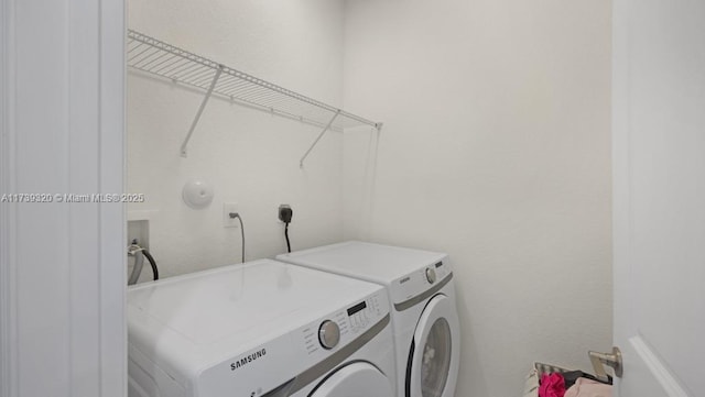 clothes washing area featuring independent washer and dryer