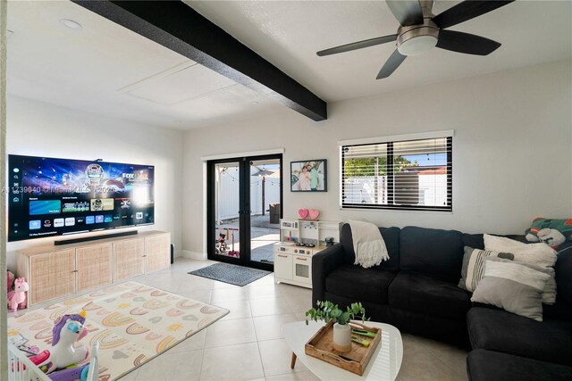 tiled living room featuring ceiling fan, beam ceiling, and french doors