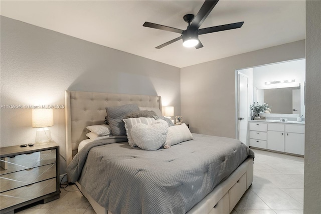 bedroom with light tile patterned flooring, ceiling fan, ensuite bathroom, and sink