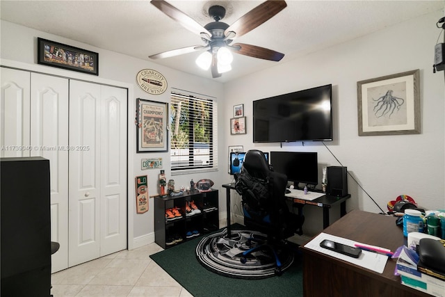 tiled office space featuring ceiling fan