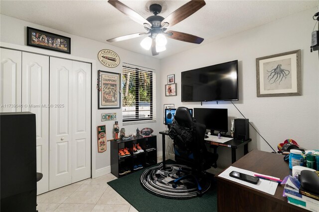 tiled office space featuring ceiling fan