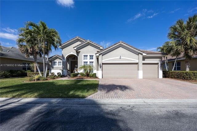 view of front facade with a garage and a front lawn