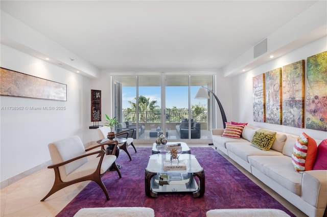 living room with visible vents, baseboards, floor to ceiling windows, recessed lighting, and tile patterned floors