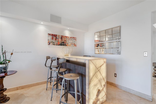 bar featuring visible vents, recessed lighting, tile patterned flooring, baseboards, and a dry bar