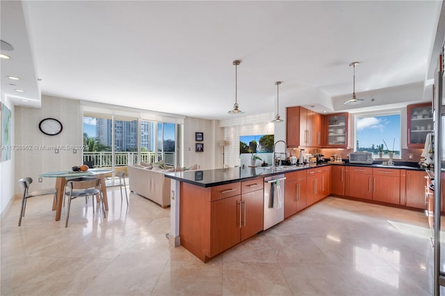 kitchen with glass insert cabinets, dishwasher, a peninsula, and a healthy amount of sunlight