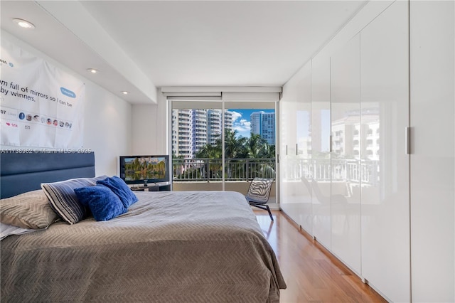 bedroom featuring recessed lighting and light wood-style flooring