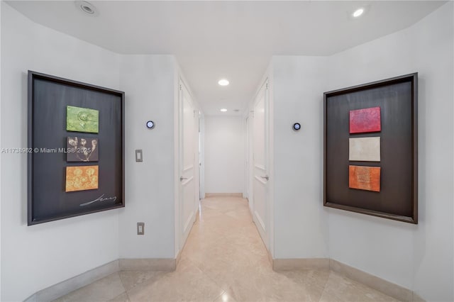 corridor featuring recessed lighting and baseboards