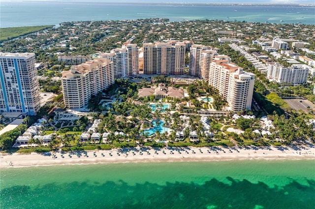 birds eye view of property with a view of city, a view of the beach, and a water view