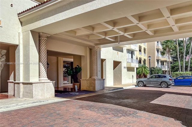 view of exterior entry featuring stucco siding and a tile roof