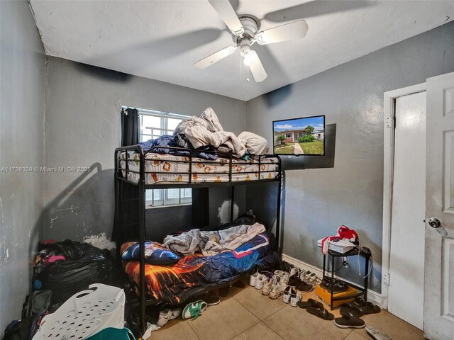 bedroom with tile patterned flooring and ceiling fan