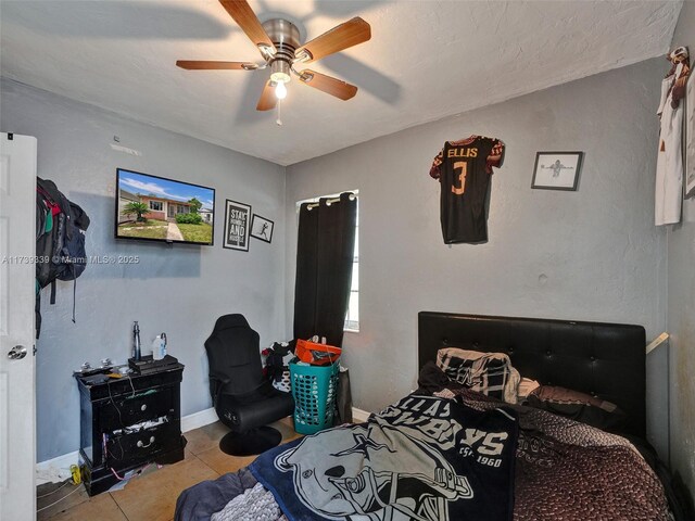 tiled bedroom with ceiling fan