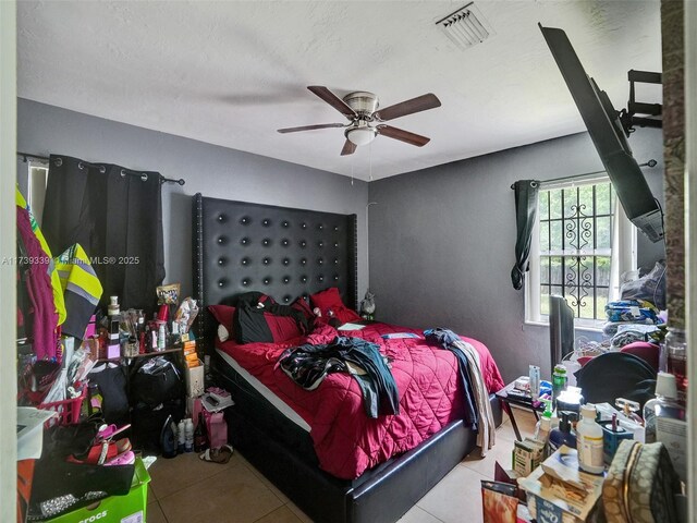 bedroom with light tile patterned floors and ceiling fan