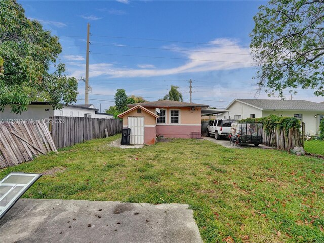 view of yard with a carport and a storage shed