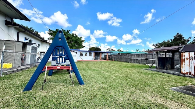 view of yard featuring playground community and a fenced backyard