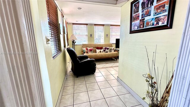 tiled living room featuring washer / clothes dryer and ornamental molding