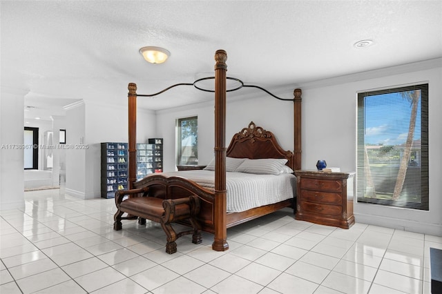 bedroom with ornamental molding, a textured ceiling, baseboards, and light tile patterned floors