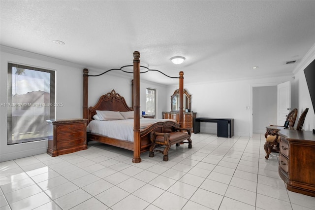 bedroom featuring multiple windows, visible vents, a textured ceiling, and light tile patterned flooring