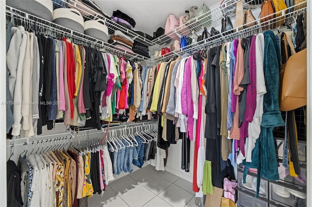 spacious closet featuring tile patterned flooring