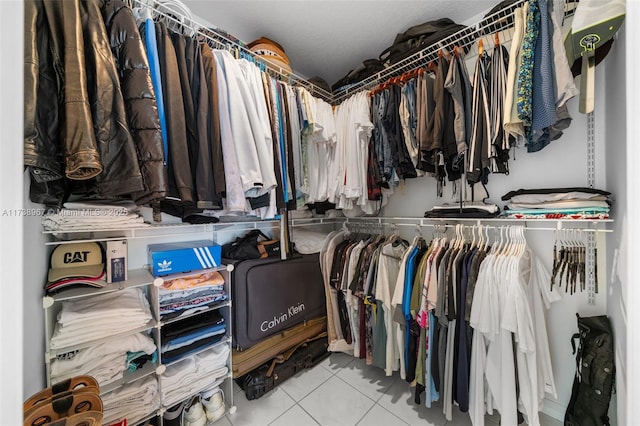 spacious closet with light tile patterned floors