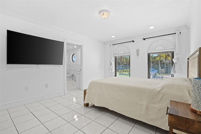 bedroom with light tile patterned floors, connected bathroom, baseboards, and crown molding