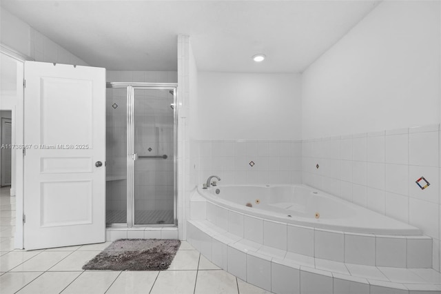 bathroom featuring a stall shower, tile patterned flooring, and a whirlpool tub