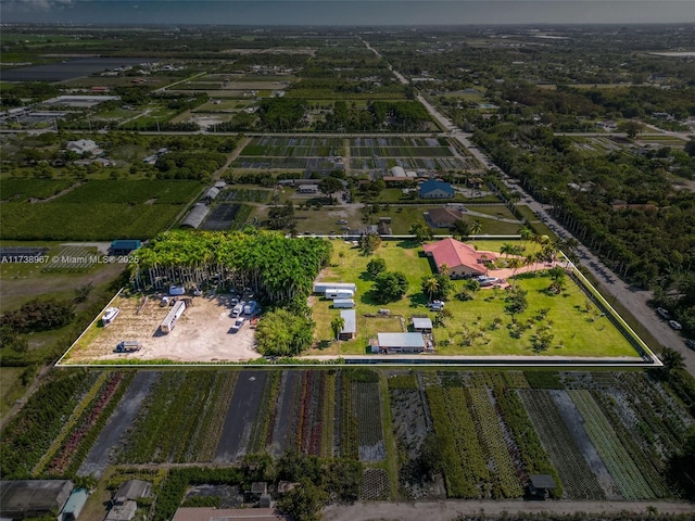 birds eye view of property with a rural view