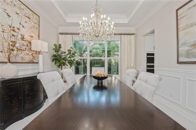 dining room featuring ornamental molding, a notable chandelier, and a tray ceiling