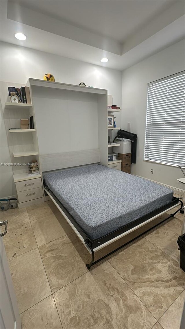 bedroom featuring a raised ceiling