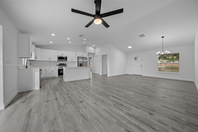 unfurnished living room with lofted ceiling, sink, ceiling fan with notable chandelier, and light hardwood / wood-style flooring