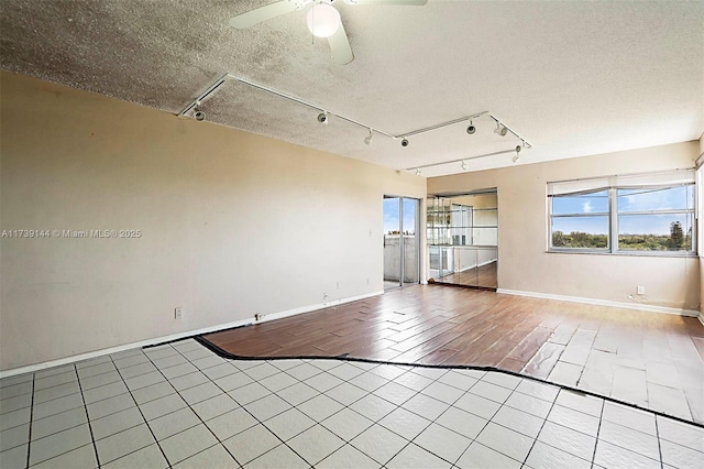 empty room with healthy amount of natural light, a ceiling fan, and tile patterned flooring