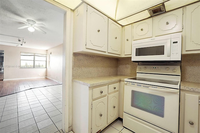 kitchen with white appliances, open floor plan, tasteful backsplash, and light countertops